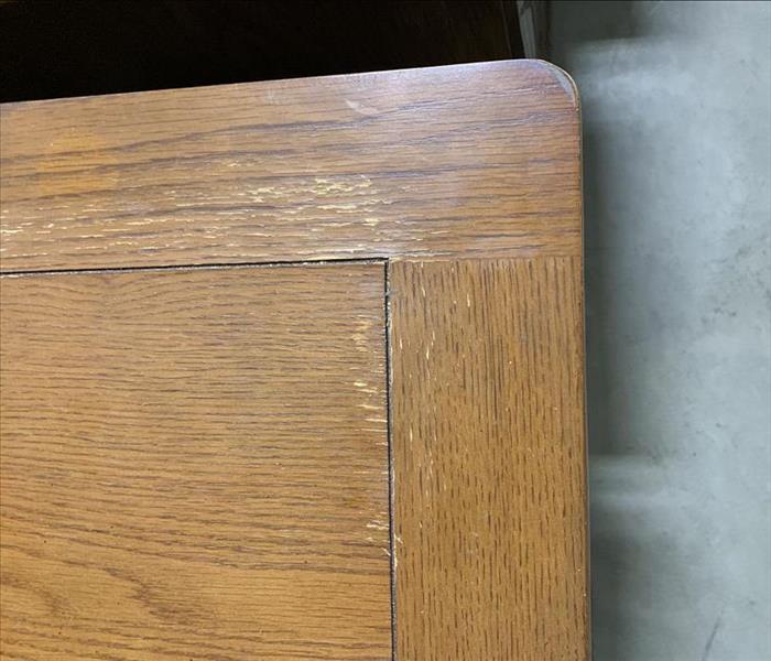 Wooden desk corner scraped up