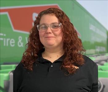 SERVPRO team member in front of new background image