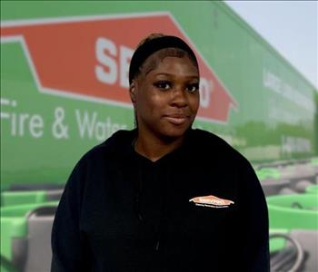 SERVPRO team member in front of new background image