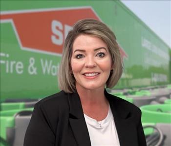 SERVPRO team member in front of new background image