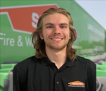 SERVPRO team member in front of new background image