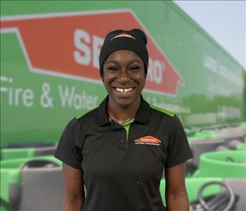 SERVPRO team member in front of new background image