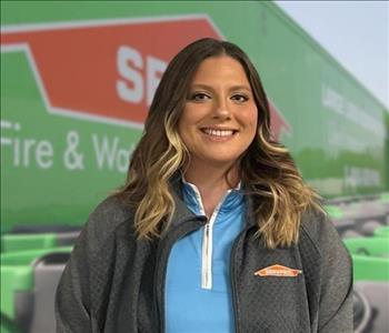 SERVPRO team member in front of new background image