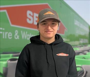 SERVPRO team member in front of new background image