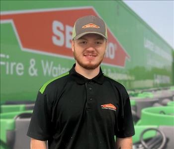 SERVPRO team member in front of new background image