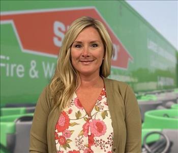 SERVPRO team member in front of new background image