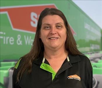 SERVPRO team member in front of new background image