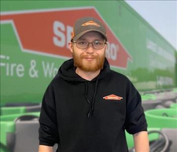 SERVPRO team member in front of new background image