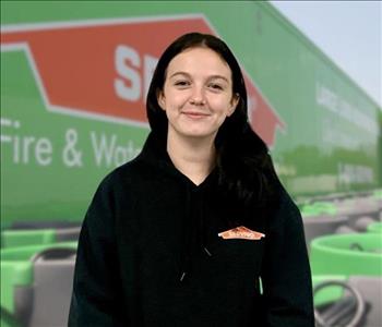 SERVPRO team member in front of new background image