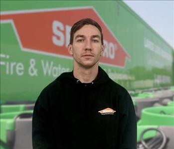 SERVPRO team member in front of new background image