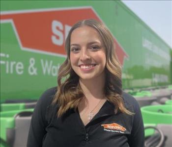 SERVPRO team member in front of new background image