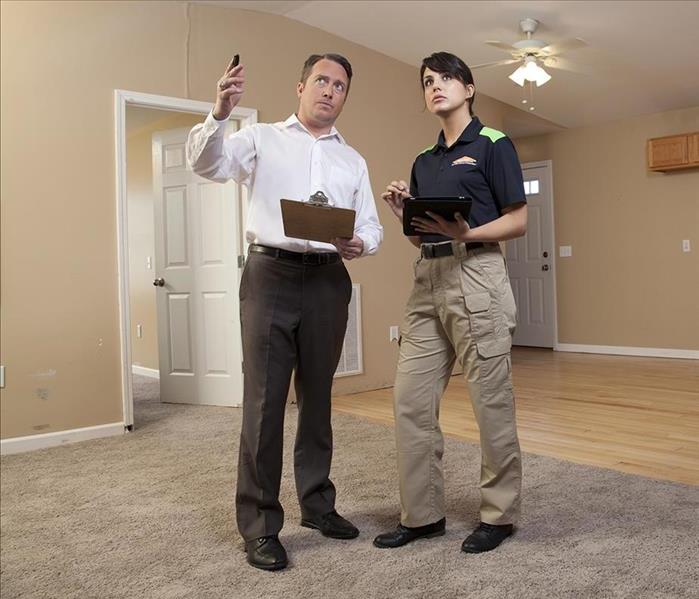A guy and SERVPRO girl having a conversation 